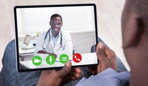 African Person Sitting With Digital Tablet