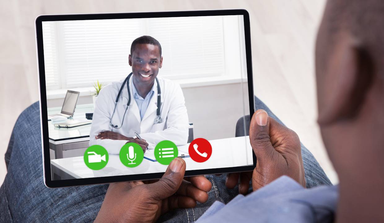 African Person Sitting With Digital Tablet