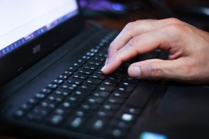 Internet surfing, hand, laptop — The Advantages of Using an Expert Service for Review Removal
